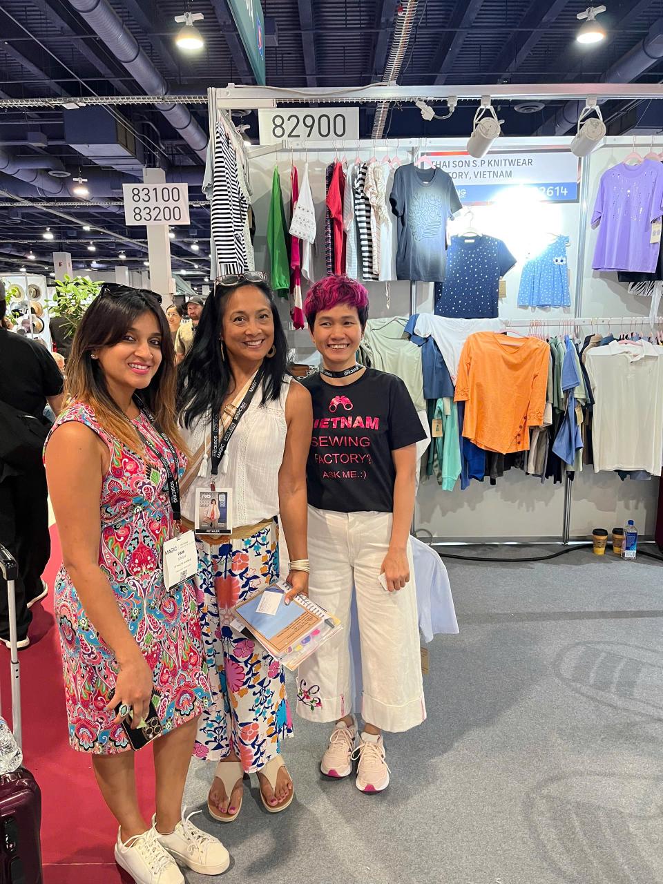 A trade show booth for the Vietnam Textile and Apparel Association, featuring clothing displays with various garments.